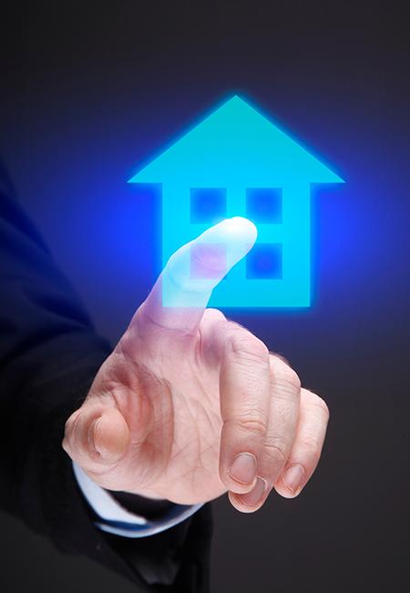 hand pointing at an illuminated clipart image of a house